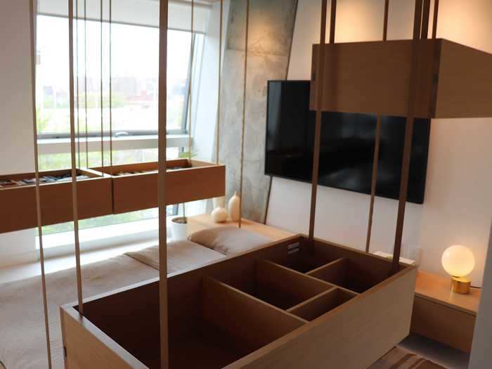 In addition to the bed, there are six storage containers that drop from the ceiling.