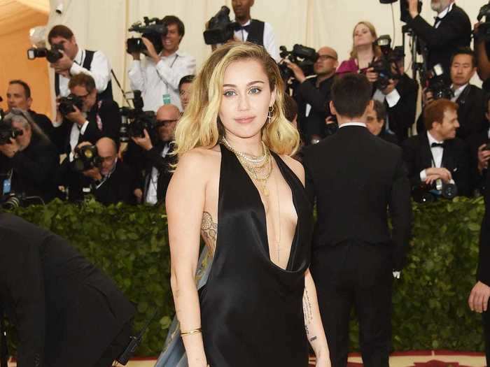 At the Met Gala that year, Cyrus looked sophisticated in a black gown with a plunging neckline.