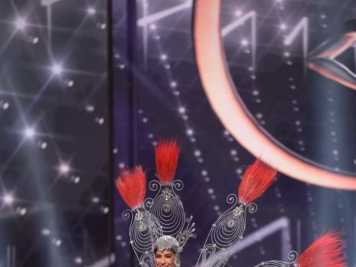 one point. Vanessa Castro Guillén, who is representing Paraguay, wore a silver-and-red bodysuit and headpiece that sparkled with more than 22 pounds of iron and stones.