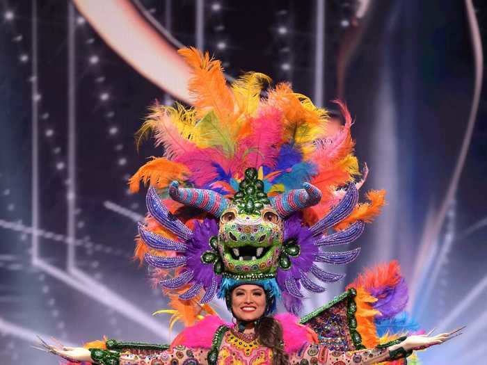 Andrea Meza, who is representing Mexico, dazzled in a multicolored bodysuit complete with wings and a headdress that were both adorned with pink, blue, green, and purple feathers.