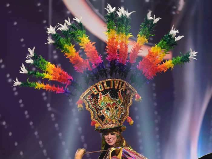 Lenka Nermer, Miss Bolivia, chose a layered, rainbow look that she paired with a matching headpiece.