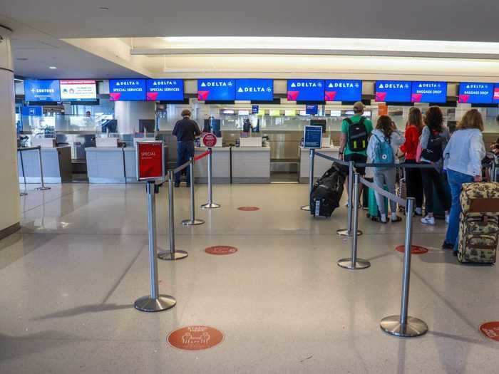 Social distancing placards guided the way to plexiglass-covered check-in counters...