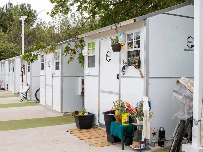 Several of these tiny homes have already been personalized with flowers, flags, and posters.