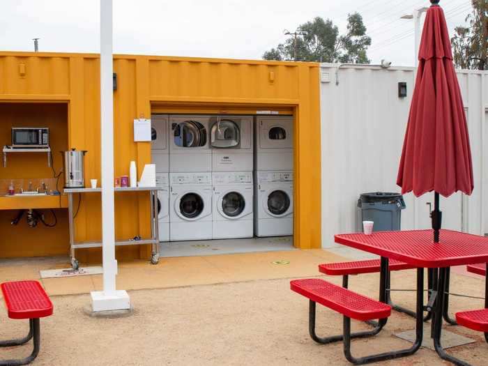 The shipping container-like buildings make up the communal facilities, which include a laundry room. It