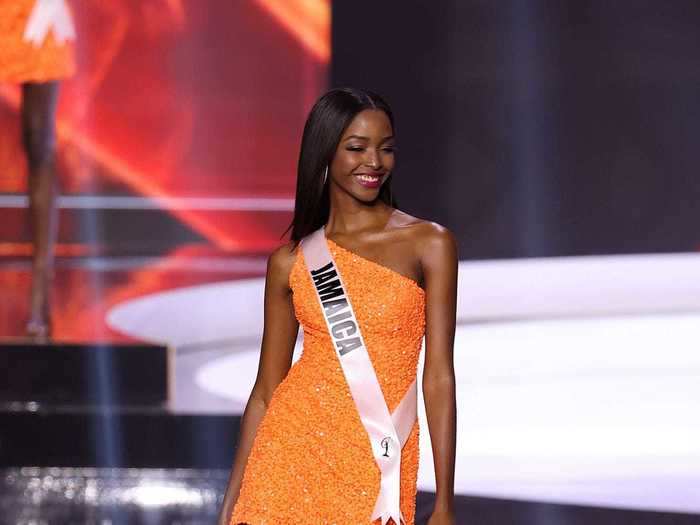 Miss Jamaica looked stunning in an asymmetrical orange dress that was covered in sparkles.