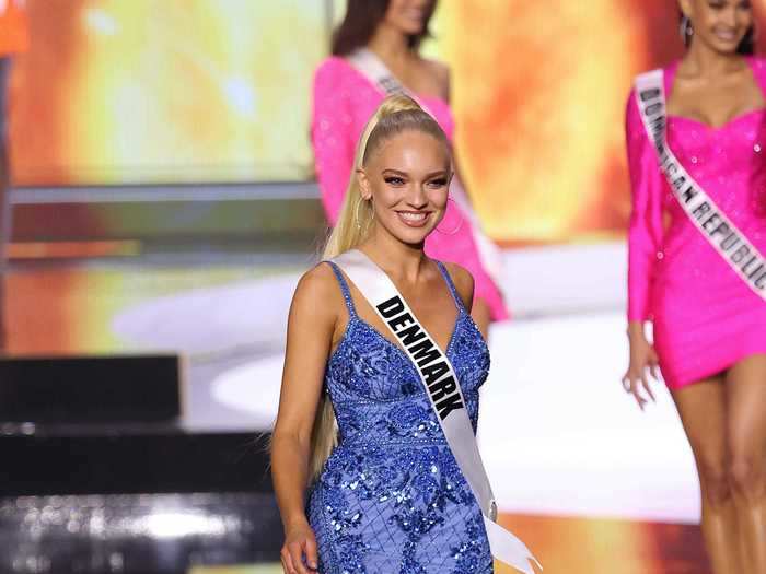 Miss Denmark paired her long ponytail with a blue dress covered in sequin details, sheer panels, and floral patterns.