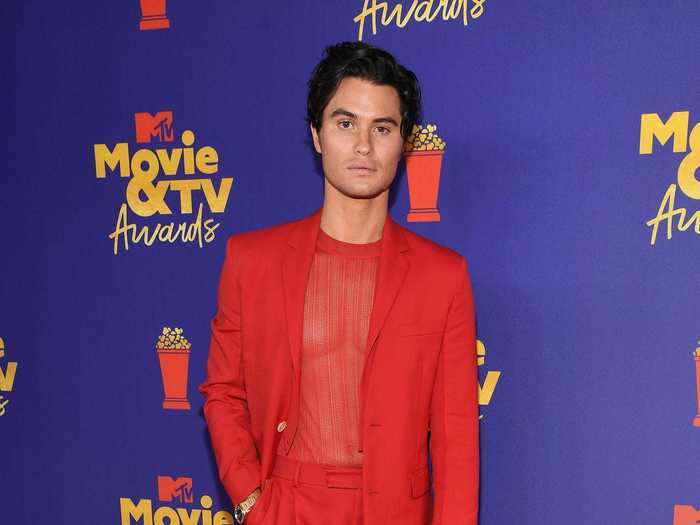 Chase Stokes wore a red suit and a sheer top to the awards ceremony.