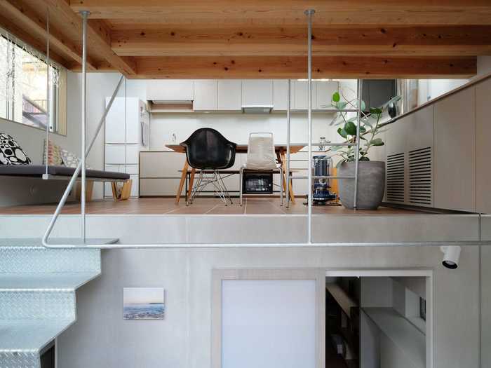 The front door leads to a mini foyer, where a metal staircase can take homeowners to the upper living area or the semi-basement.