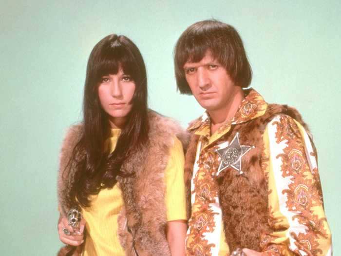 In 1968, Cher wore striped pants, a yellow shirt, and fur in a portrait with Sonny.