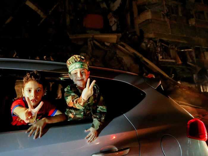 Happy children flashed peace signs during the celebration after days of bombing devastated the city.