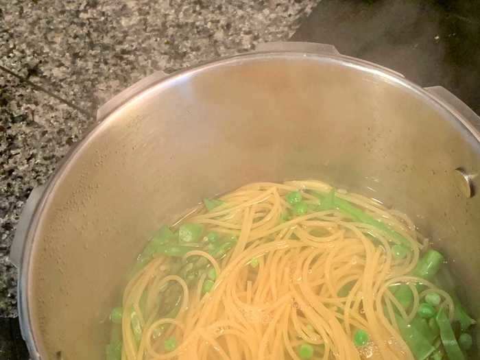 Once the eight minutes were up, I saved a cup of the pasta water and then added some of the veggies.