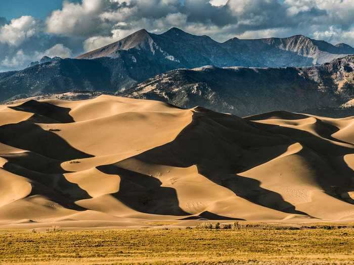 You can sled or sandboard down a 742-foot-tall mountain of sand at Great Sand Dunes National Park in Colorado.