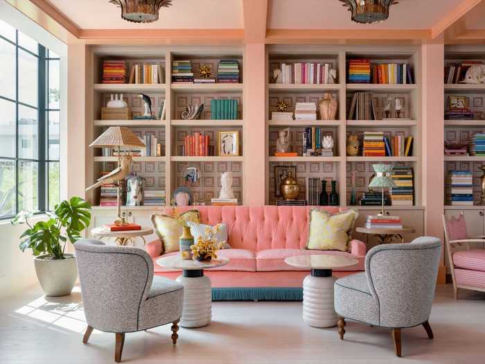 To end the day, guests can unwind in the peach-toned library filled with whimsical touches like a parrot-themed lamp and bright pink sofa.