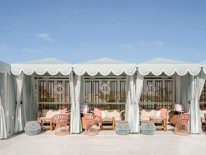 At Strawberry Moon, guests can relax under cabanas with scalloped fringe awnings while enjoying Mediterranean fare and cocktails from the nearby restaurant and bar.