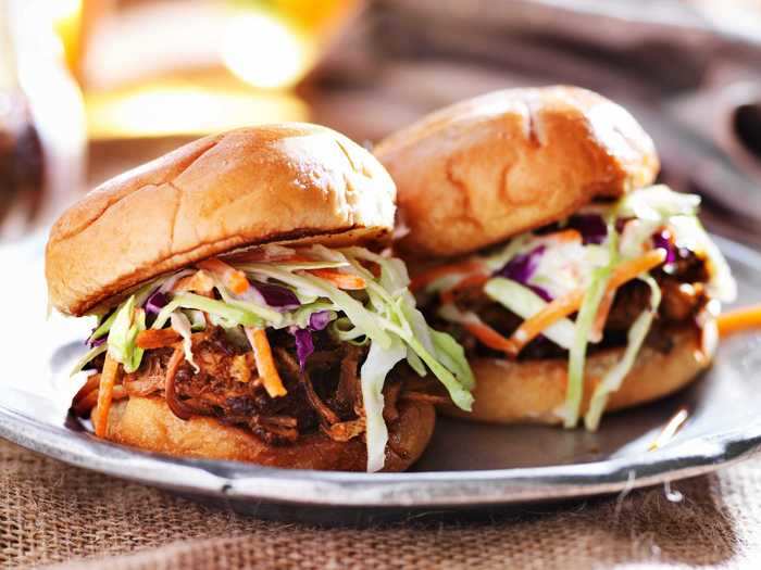 Pulled pork sliders are a great way to use your slow cooker for a Memorial Day cookout.