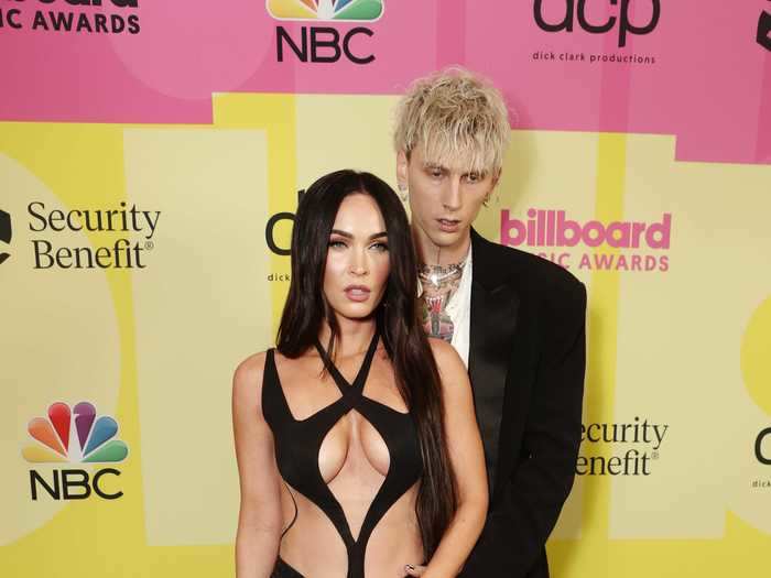 Megan Fox, accompanied by Machine Gun Kelly, wore a barely there black gown at the Billboard Music Awards.