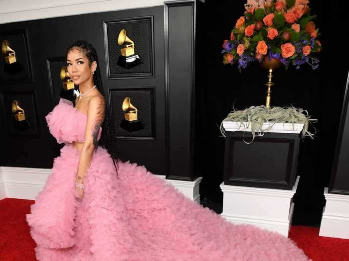 Jhené Aiko brought the drama to the Grammys red carpet in this pink gown and a long, ruffled train.
