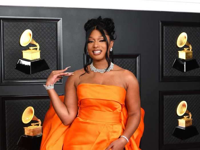 Megan Thee Stallion wore a vibrant orange gown and matching orange heels to slay the Grammys this year.