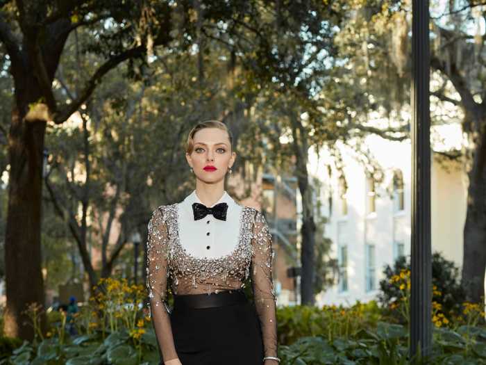 Amanda Seyfried put a spin on the classic tuxedo look with a brown sparkly shirt and a red lip at the Critics
