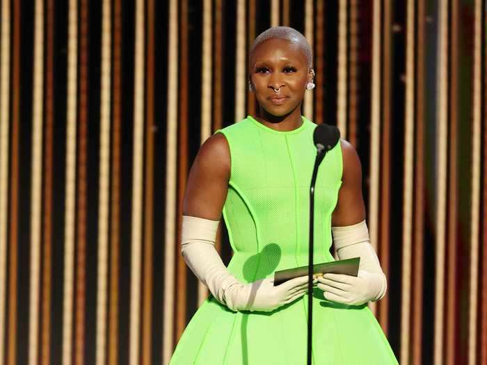 Cynthia Erivo presented at the Golden Globes in this structured lime green dress, long white gloves, and sky-high heels.