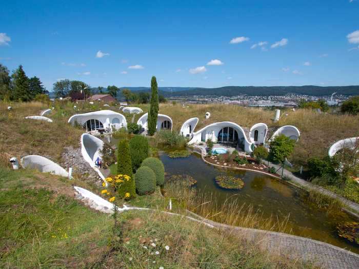 A collection of earth houses are tucked beneath the grass in Dietikon, Switzerland.
