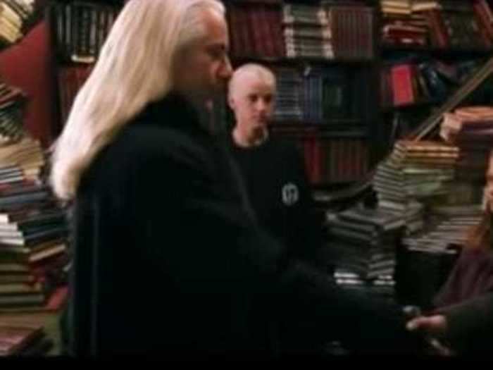 Lucius Malfoy adds flashy accessories to his look.