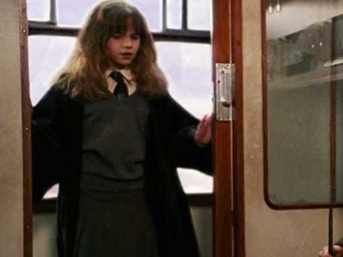 Even from her very first scene, Hermoine is ready for school in her Hogwarts robes.