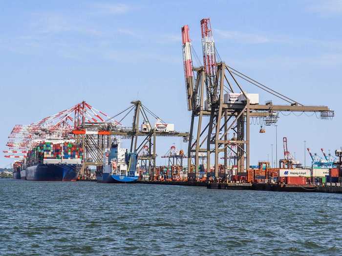 Massive cranes greet the ships and immediately begin offloading and loading containers in a real-world game of Tetris.