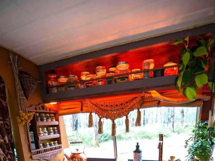 The kitchen features open shelving and hand-painted cabinets.