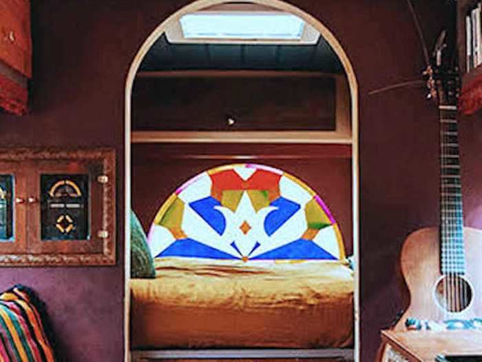 The bedroom space also has a skylight and faux stained-glass window.