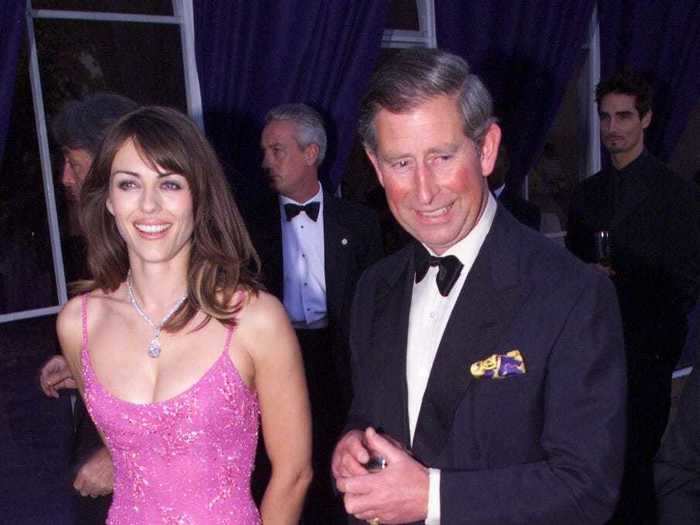 Liz Hurley was wearing a glamorous gown with daring details when she met Prince Charles in 1999.