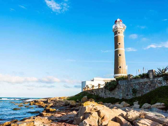 The sandy color of the Jose Ignacio Lighthouse in Uruguay blends in with the surrounding rocks and dunes.