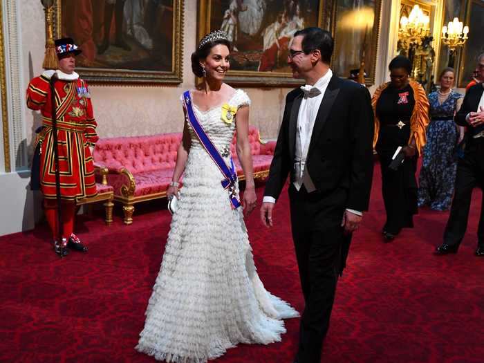 Middleton also wore white - a ruffled Alexander McQueen gown - to the event at Buckingham Palace.