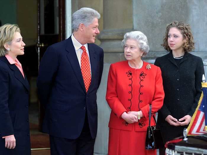 She wore a red skirt suit with black detailing to tea with the Clintons at Buckingham Palace in 2000.