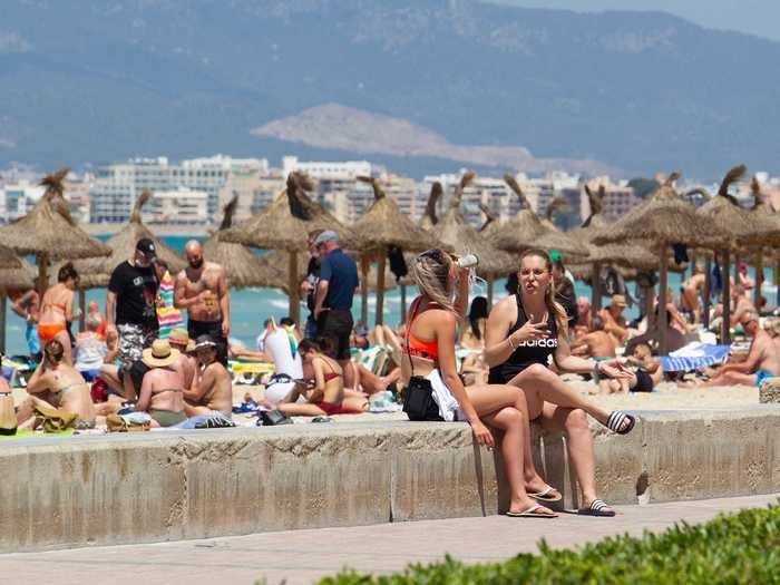 Beachgoers soaked up rays in the Spanish resort town of Mallorca on Monday.