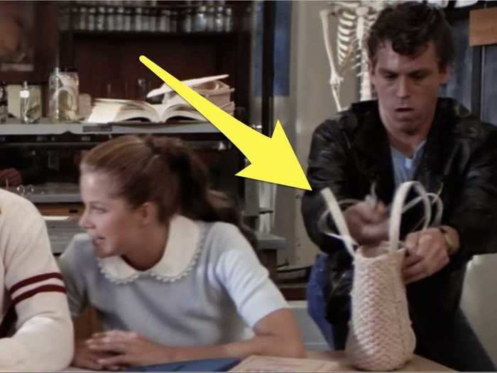 Kenickie pranks a girl in homeroom on the first day of school.