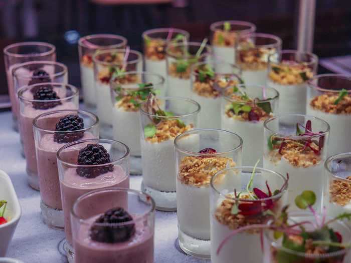 Due to the pandemic, buffet attendants plate food items for guests and deliver them on a tray.