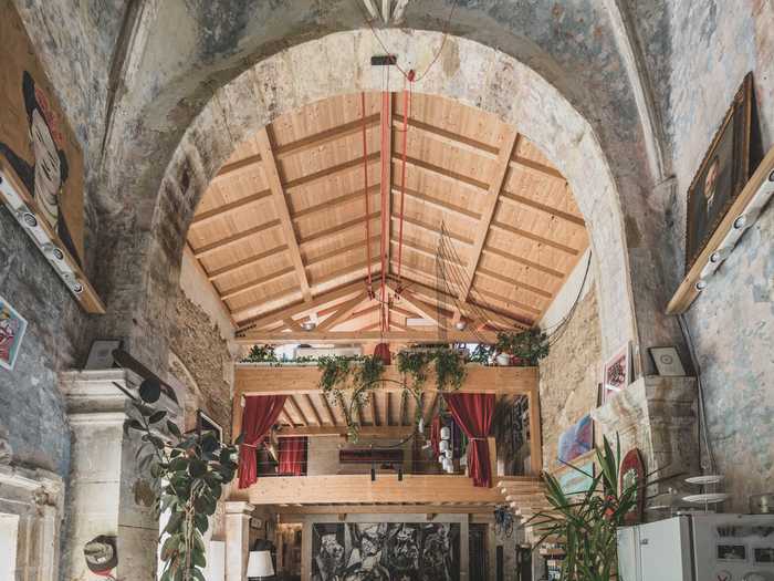 A wooden staircase leads to the second-story loft.