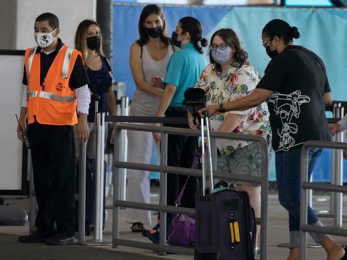 Lines of people waiting to board a cruise ship may seem like an unfamiliar sight to most Americans now.