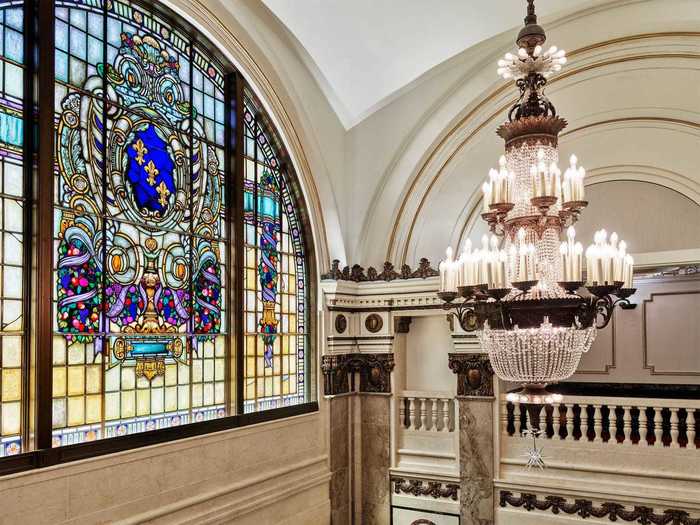 A stained glass window and a chandelier at the Tower Theater Apple Store