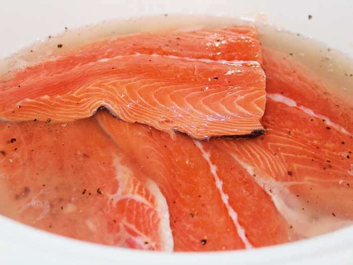 I seasoned the four salmon fillets with salt and pepper and added them to the slow cooker.