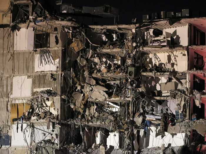 A zoomed-in shot after the collapse shows tattered units and belongings.