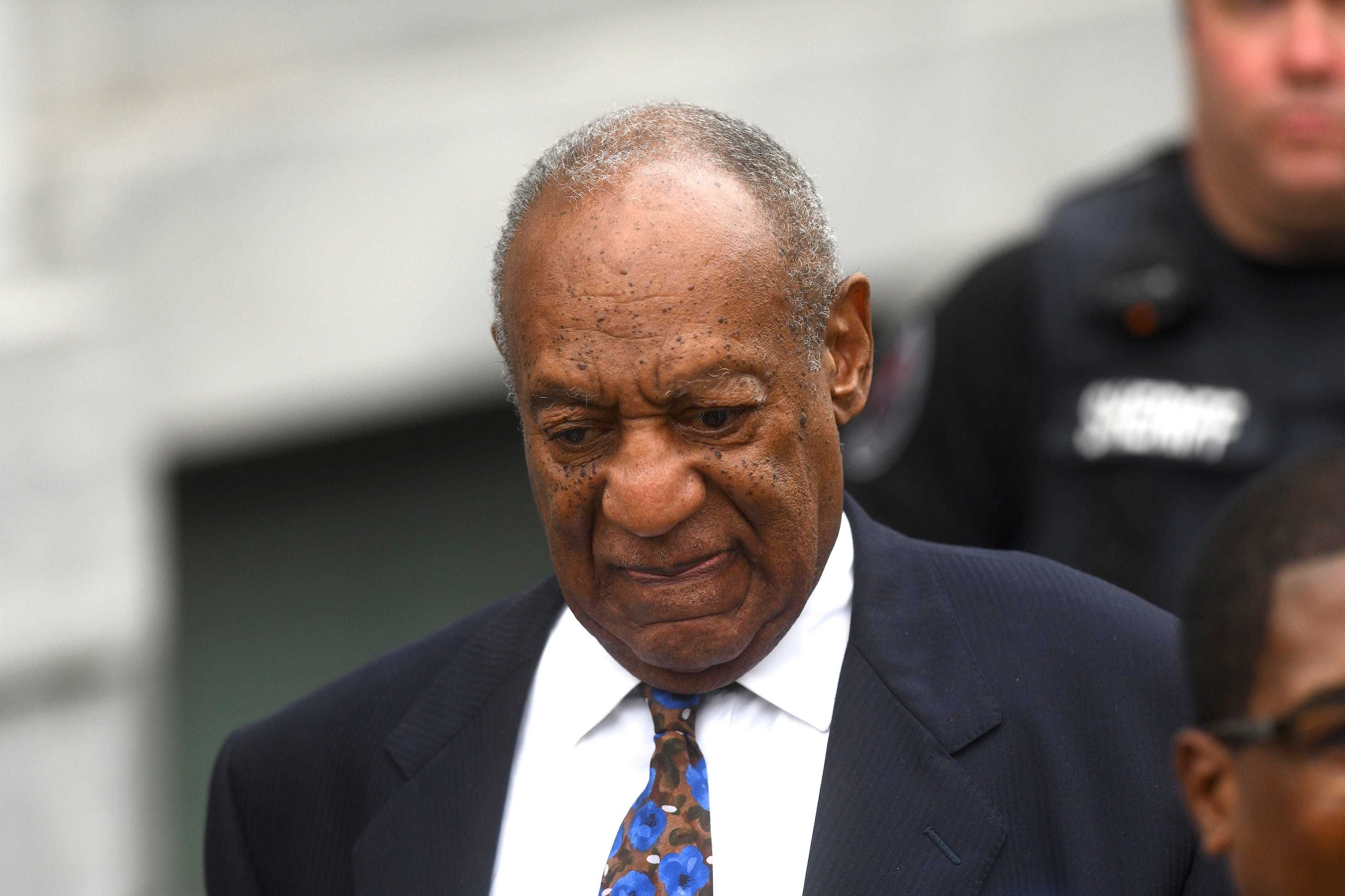 Bill Cosby leaving a courthouse