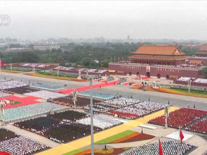 Tidy rows of thousands of audience members gathered, mostly unmasked, listening to Xi.