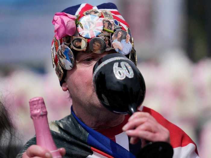 Some royal fans popped champagne and toasted the princess in front of the gates of Kensington Palace in London.