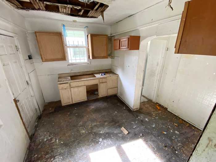 Once inside, I found a kitchen with no appliances, countertops, or even a ceiling.