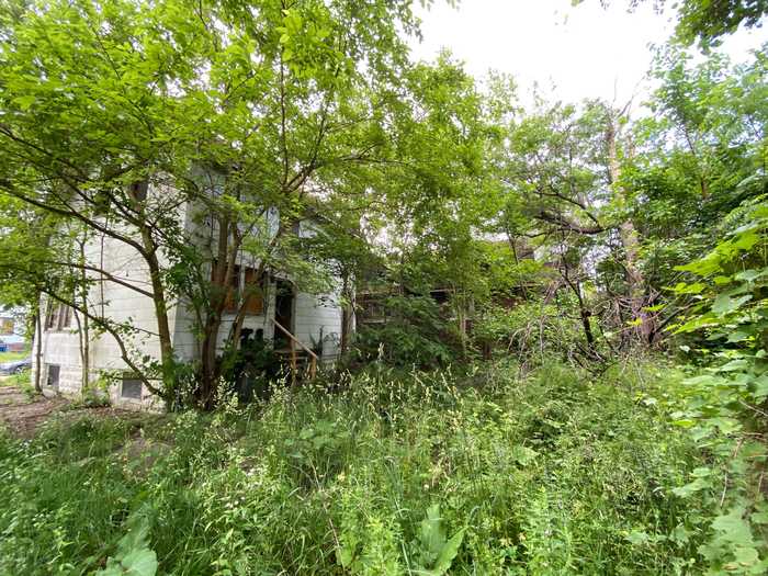 I had to enter the house through the back because of the broken front porch and boarded-up front door.