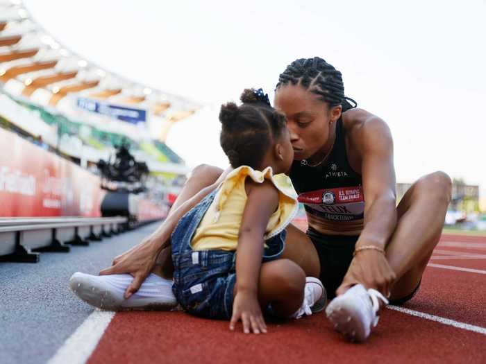 6/20:  Allyson Felix celebrates with her daughter, Camryn, after finishing second in the 400-meter Final to qualify for the Tokyo Olympics.