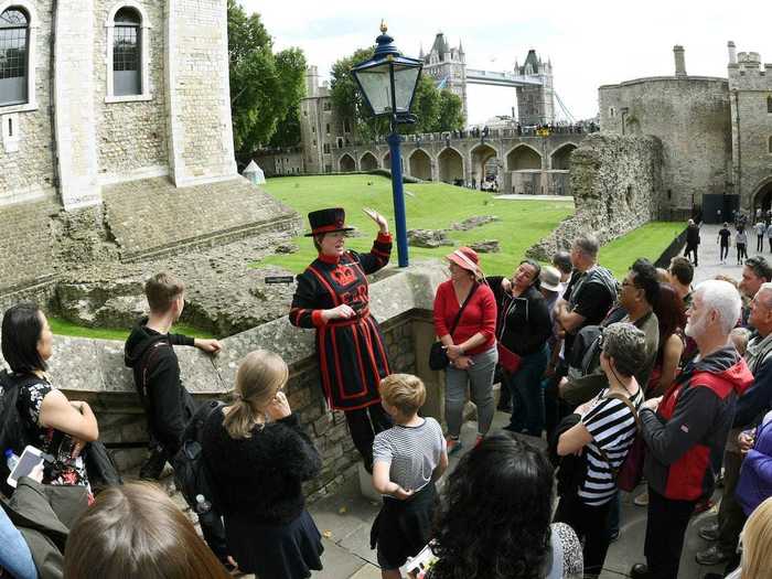 As Houghton walks to his front door, he passes crowds of tourists surrounded by "beefeaters," which are the Tower