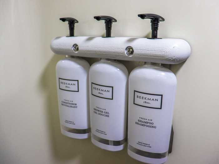 The new upgrades in the shower include dispensers for the soap, shampoo, and conditioner.